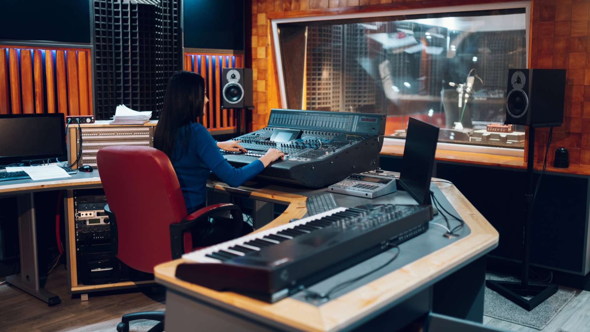 woman-music-producer-working-on-a-mixing-soundboar-2023-11-27-05-24-07-utc